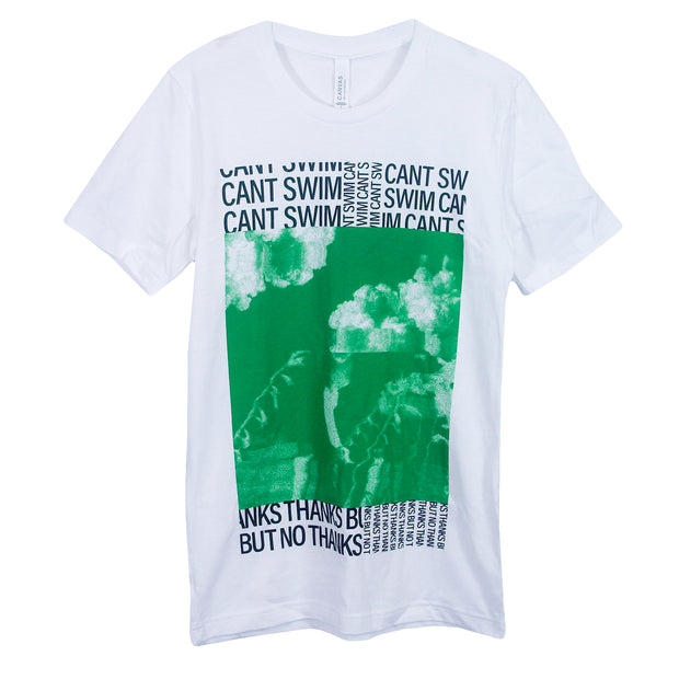Can't Swim Thanks But No Thanks White T-Shirt. Center of shirt is a person with a few flowers surrounding them that turns into clouds by their head in green ink. Above that is "Cant Swim" text in a collage format in black ink. Below image is "Thanks But No Thanks" text in collage format in black ink. 