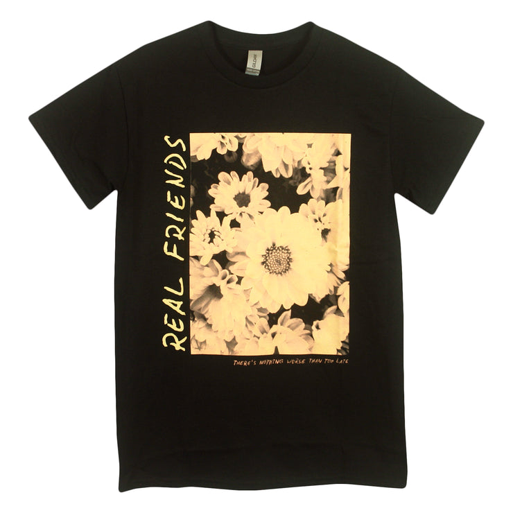 Real Friends Too Late Black Tee Shirt. square of flowers in the center in sepia tone colors. Real Friends text in yellow down the left side of image. There's nothing worse than too late printed under the image