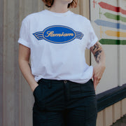 image of a girl wearing a white tee shirt. Front of shirt has a Samiam logo crest in blue and gold in the center