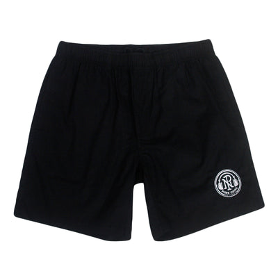image of a pair of black beach shorts on a white background. there is a small embroidered circle on the bottom right showcasing pure noise records logo on the letters P N with headphones around and arched up pure noise records below.