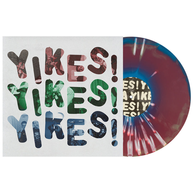 Dollar Signs YIKES vinyl LP, with the vinyl exposed to show color. Album art is the text YIKES! repeated 3 times in red, green, then blue with a white background. color of vinyl is Blue, Oxblood, Green Aside/Bside with White Splatter.