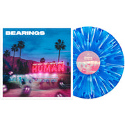 Bearings The Best Part About Being Human Vinyl LP. Album art depicts a diner with a mountain and palm trees in the background. spooky looking lights seem to be entering the diner. vinyl is exposed to show color. color of vinyl is Royal and cyan blue Aside/Bside with white and purple splatter.