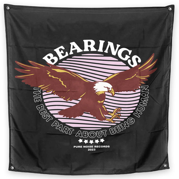 Bearings The Best Part About Being Human Wall Flag. black square wall flag with eagle in flight in the center. has a pink circle design behind it. the text Bearings above the eagle and the text The Best Part About Being Human under the eagle 